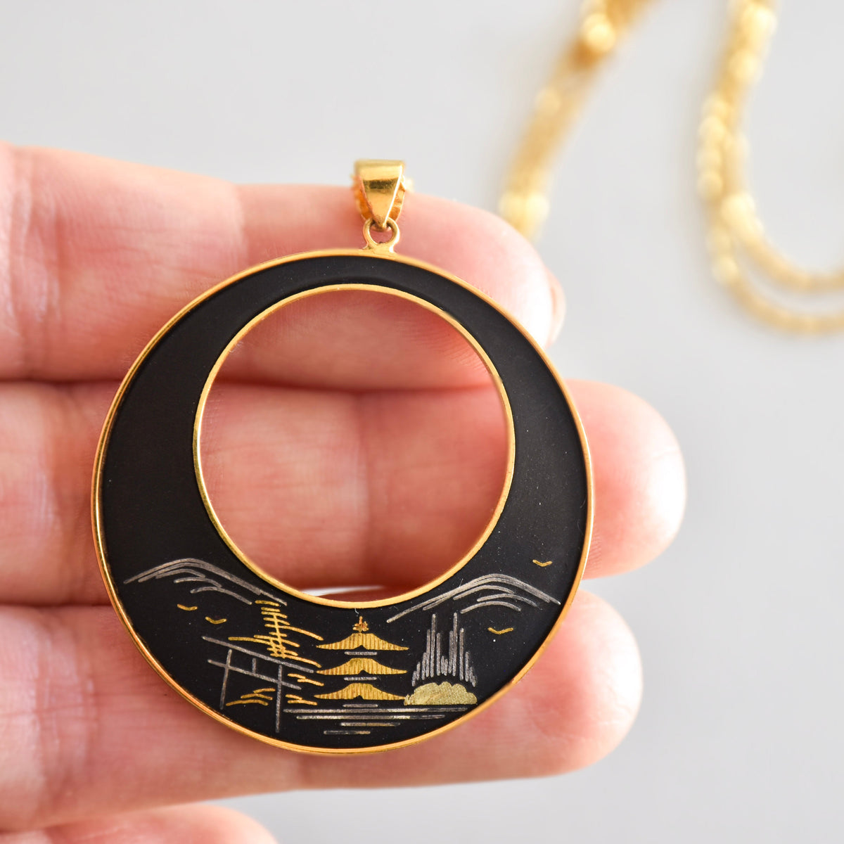 Vintage Japanese necklaces and pendants featuring lacquered wood, pearls, and traditional craftsmanship.