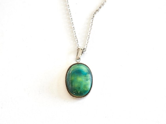 Green Oval Kutani pendant necklace closeup showing the ceramic glaze pattern