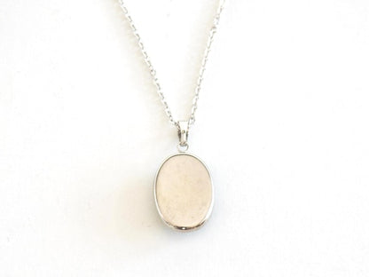 Green Oval Kutani pendant necklace shown from the back of the ceramic piece