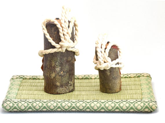 Japanese Inuhariko Guardian Dog Figurines kokeshi dolls, back view showing natural wood texture and twisted rope