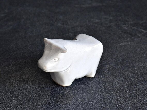 Japanese ceramic cow figurine showing front angle and smooth white glaze