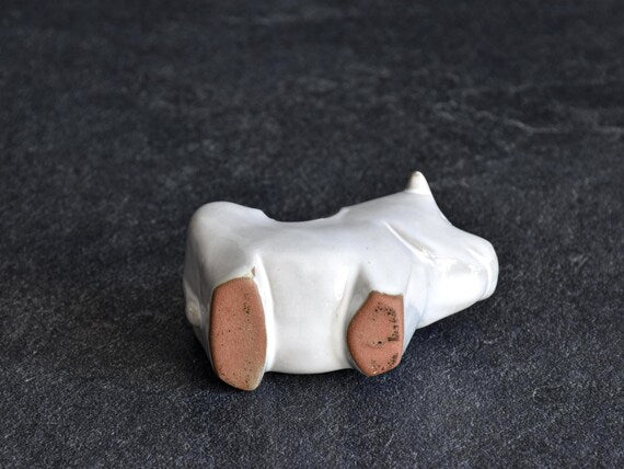Japanese ceramic cow figurine showing base and unglazed feet
