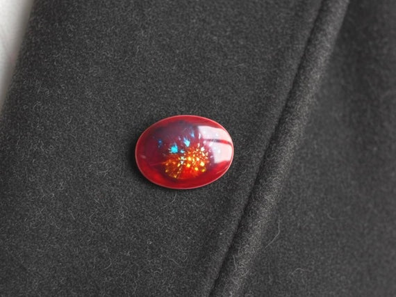 Kutani Dark Red Ceramic Brooch attached to a dark wool jacket lapel displaying the accessory worn on fabric