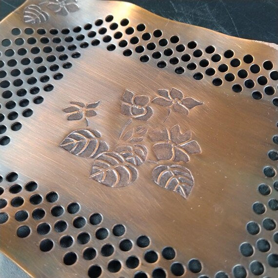 Copper Openwork Floral Saucers close up of center engraved floral motif on copper plate