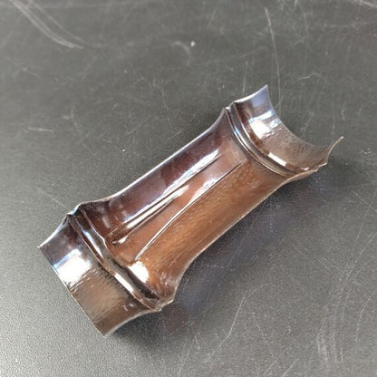 Copper Openwork Floral Saucers - Set Of 5 copper chopstick rest closeup on dark surface