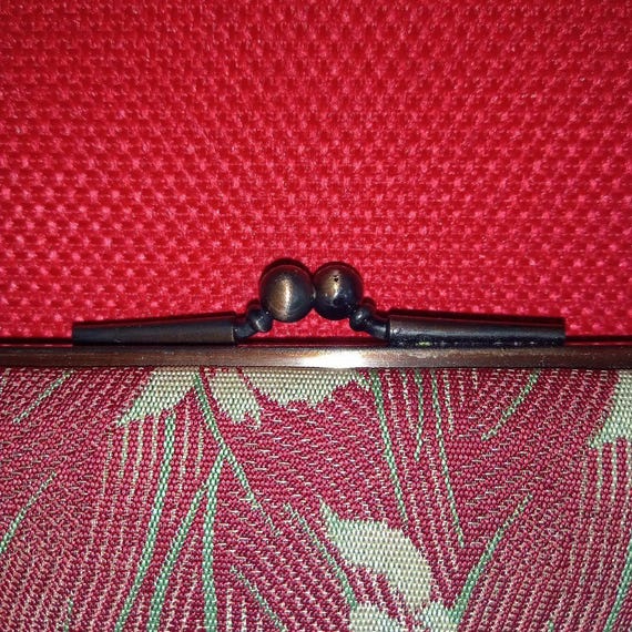 Hakata-ori Silk Wallet: Iris Motif close up of the traditional metal gamaguchi clasp