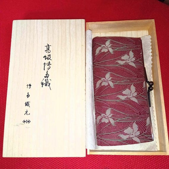 Hakata-ori Silk Wallet: Iris Motif coin purse resting in its original wooden presentation box