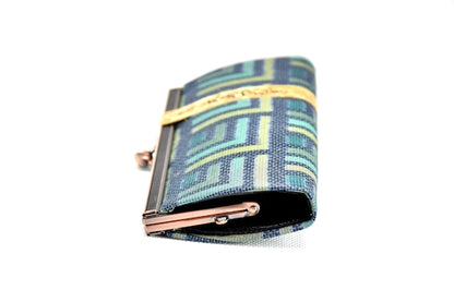 Oshima Tsumugi silk coin purse side view showing the slim profile and metal frame closure