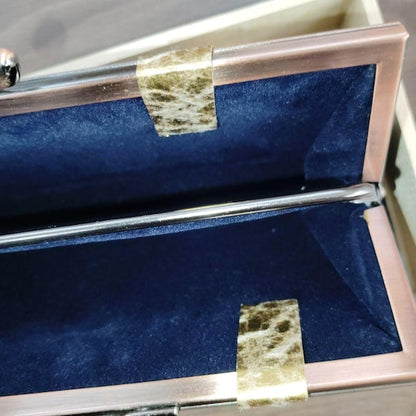 Oshima Tsumugi silk coin purse close up of the clasp mechanism and dark blue interior