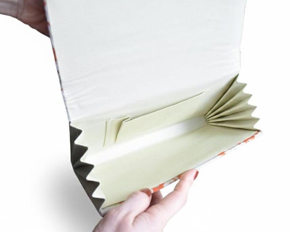 Kimono clutch interior showing the fitted fabric pocket and structured gusset details up close