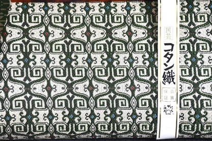 Kotan-Ori Kimono Bag close up showing the Ainu inspired green and ivory woven pattern and paper label