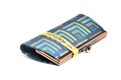 Oshima Tsumugi silk coin purse angled view displaying the metal clasp and geometric pattern