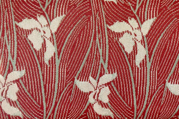 Hakata-ori Silk Wallet: Iris Motif pattern detail of the woven red and gold silk fabric