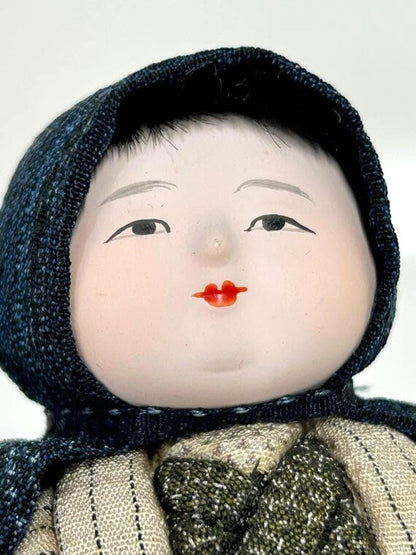 Omeshi Ningyō Doll traditional Japanese kokeshi doll close-up of hand-painted face with calm expression
