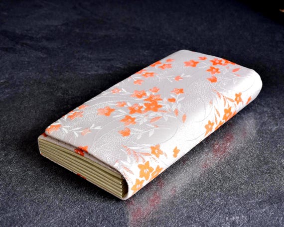 Kimono clutch bag viewed from the back, showing the smooth pearly beige base and kimono fabric pattern