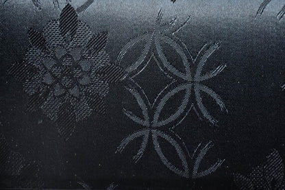 Black Floral Woven Clutch macro close-up view of the woven floral pattern