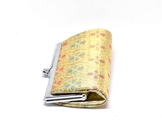 Saga Nishiki coin purse side view showing the fold and metal frame