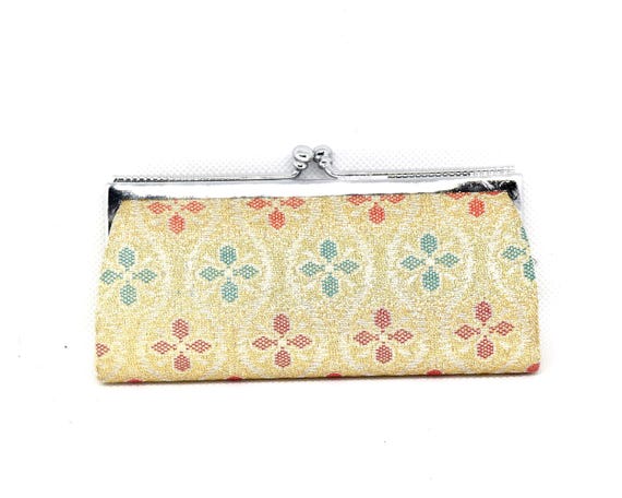Saga Nishiki coin purse front view displaying the orange yellowish-green and yellow pattern