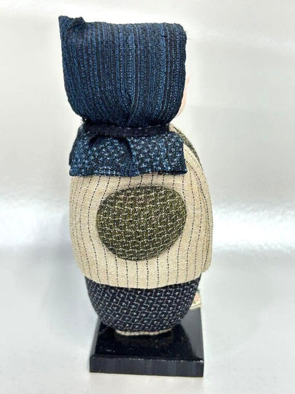 Omeshi Ningyō Doll traditional Japanese kokeshi doll side view showing detailed textile texture and wooden base