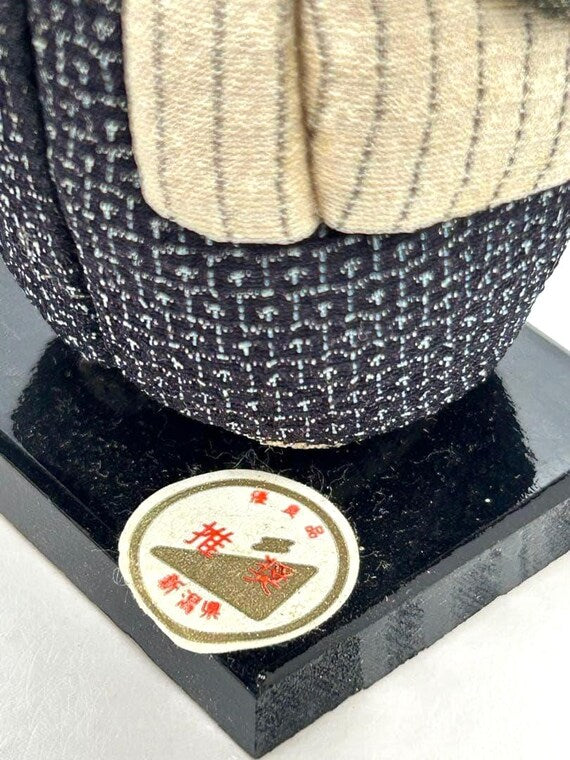 Omeshi Ningyō Doll traditional Japanese kokeshi doll close-up of region sticker on the wooden base