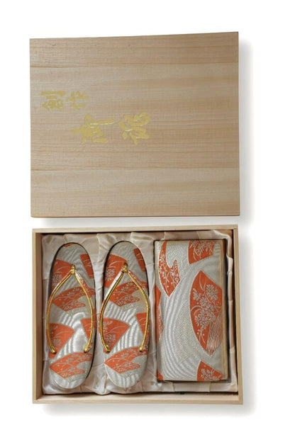Gold Brocade Zori Sandals And Clutch Set displayed with the lid of the wooden storage box resting above the set