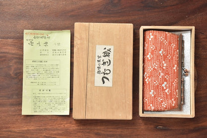 Kaga Yuzen Silk Coin Purse laid out with its original wooden box and explanatory leaflet