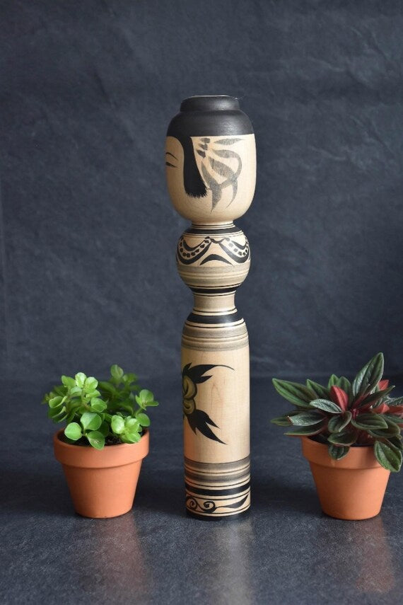 Zenji Sato kokeshi doll showing the opposite side with painted floral elements