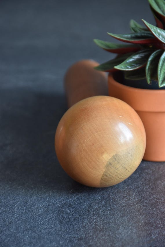 Kokeshi Doll Floral Pattern close-up of the rounded wooden head showing aging and grain