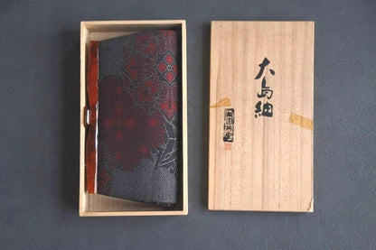 Oshima Tsumugi Kimono Bag neatly placed inside its original open paulownia wood box