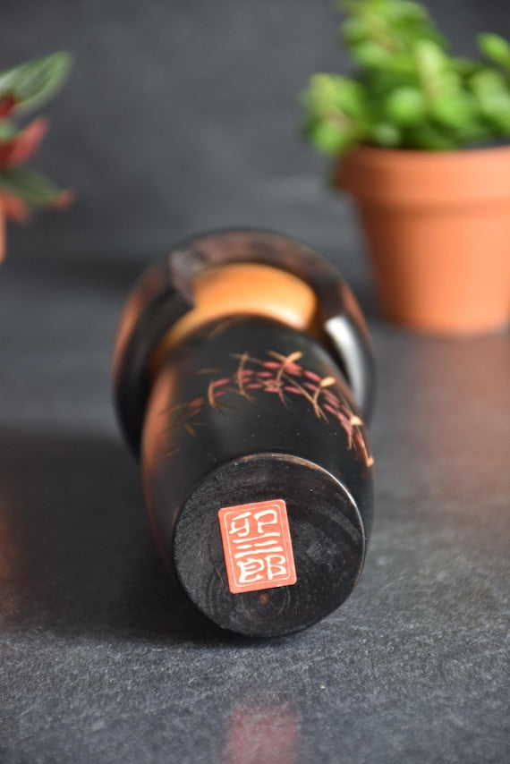 Usaburo Creative Kokeshi Doll base showing the red square sticker seal with Japanese characters