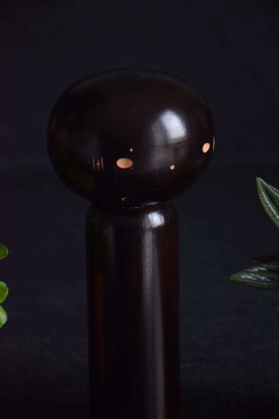 Japanese Kokeshi Doll pattern detail closeup showing the minimal facial features