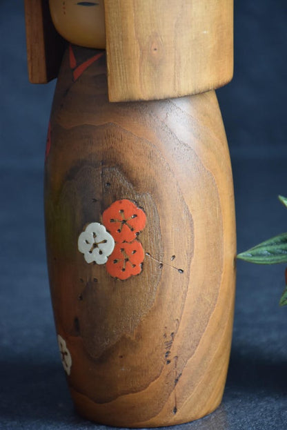 Usaburo Kokeshi Doll Ume No Hana close-up of the red and white plum blossom kimono pattern