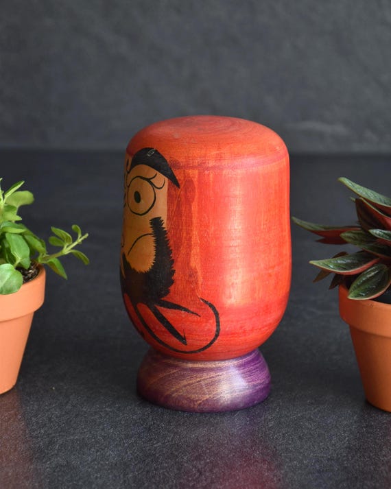 Japanese Daruma Figurine kokeshi doll side profile showing hand-painted facial features