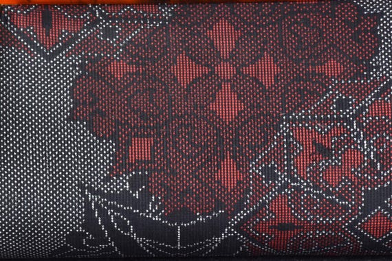 Oshima Tsumugi Kimono Bag pattern detail showing fine woven red and black geometric silk textile