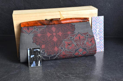 Oshima Tsumugi Kimono Bag with included small mirror and decorative paper tag in front of box