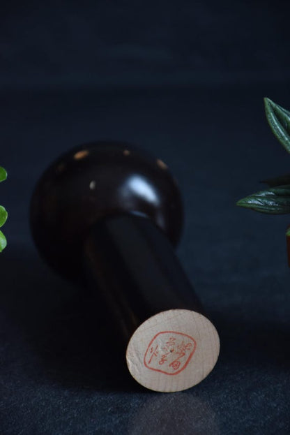 Japanese Kokeshi Doll base with signature stamp on the bottom of the wooden piece