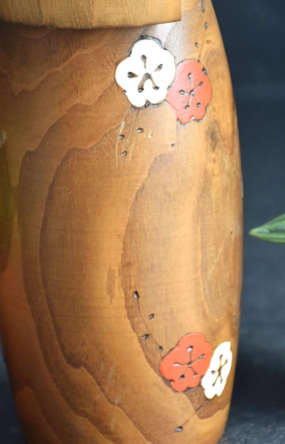 Usaburo Kokeshi Doll Ume No Hana pattern detail showing painted and wood-burned red and white blossoms