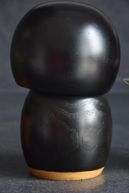Kazuo Takamizawa creative kokeshi doll close up view of the textured black wooden back