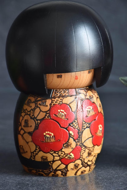 Kazuo Takamizawa creative kokeshi doll close up of wood incised red and harvest orange kimono