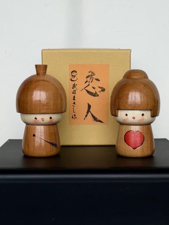 Masashi Takeda Lovers Kokeshi Dolls shown in front of their original storage box