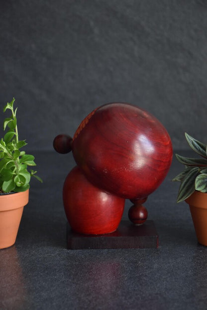 Chie Tamura Pigtail Kokeshi doll back view showing rounded wooden shape on stand
