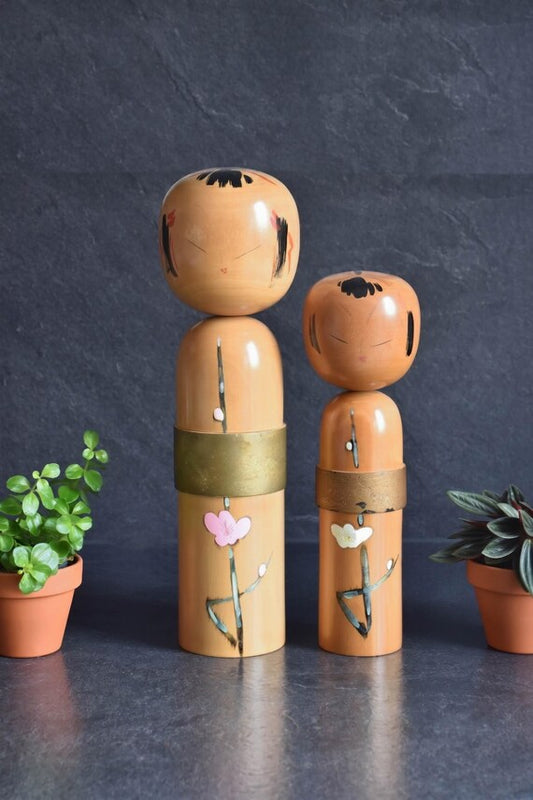 Takahashi Hashime Iroume Kokeshi Pair handmade vintage Japanese wooden dolls decorated with plum branch motifs