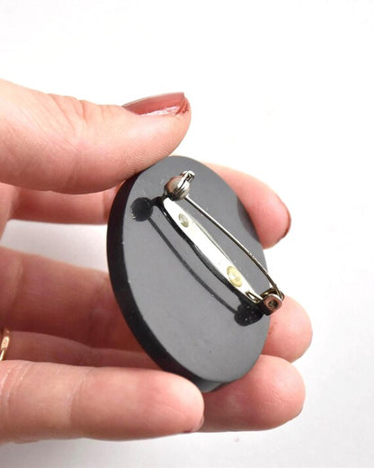 Raden shell inlay brooch back with clasp held in hand