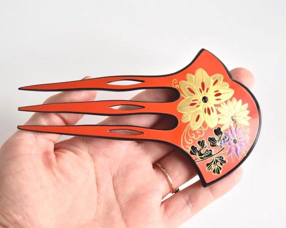 Japanese Red Lacquer Fork hair comb held in hand to show size