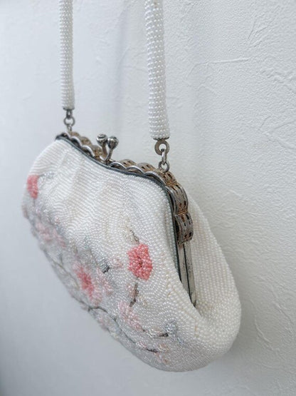 Japanese Floral Beaded Clutch Bag angled view against a neutral wall showing the beaded handle