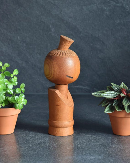 Aida Seihou kokeshi doll viewed from a slight angle emphasizing the natural grain of the wood