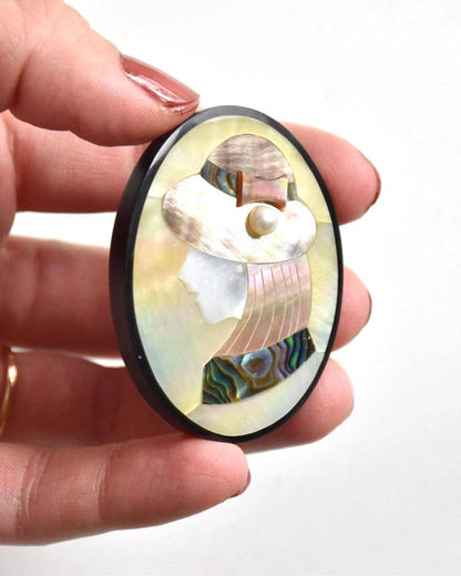 Raden Shell Inlay Portrait Brooch vintage Japanese mother-of-pearl lapel pin held in hand
