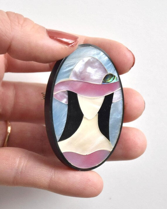 Raden shell inlay brooch viewed from the side held in hand