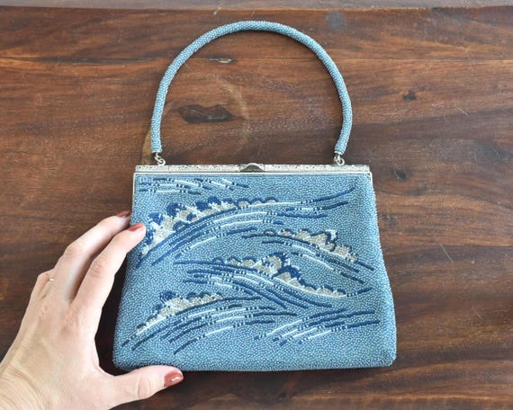 Japanese Blue Glass Bead Clutch shown next to a hand for size scale perspective
