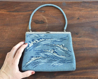 Japanese Blue Glass Bead Clutch shown next to a hand for size scale perspective